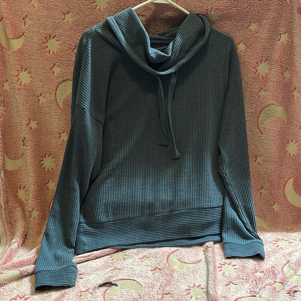 Natural Reflections Woman’s blue high neck shirt with drawstrings